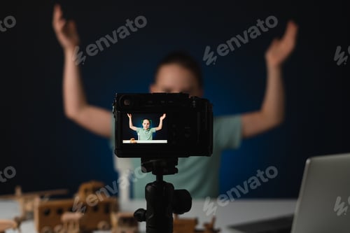Preview: Young guy streaming feeling victorious. He celebrates his big number of followers, focus on screen