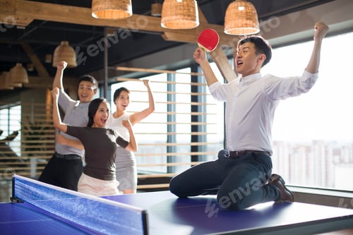Preview: Young businessman playing ping pong