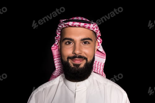Preview: smiling muslim man looking at camera isolated on black