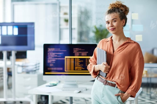 Preview: Female young programmer working at office