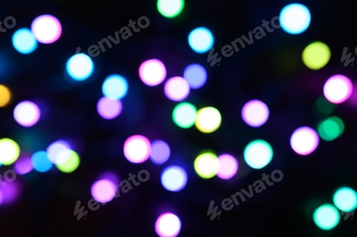 Preview: blurred night multicolored glowing lights on black background. new year and christmas concept
