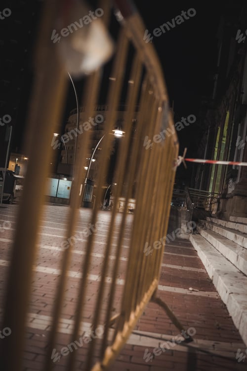 Preview: Low angle vertical shot of urban fences in the night