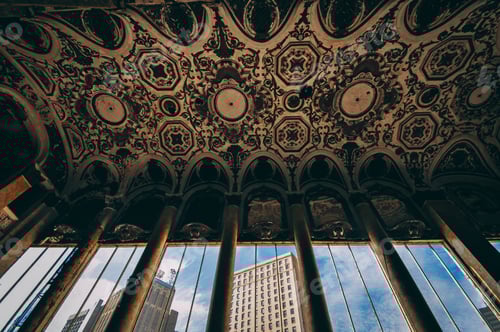 Preview: Ceiling of an ancient building with columns and a view of modern buildings from the windows
