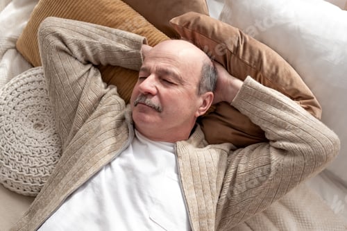 Preview: Senior hispanic man resting at home sleeping on bed. Grandfather having a nap.