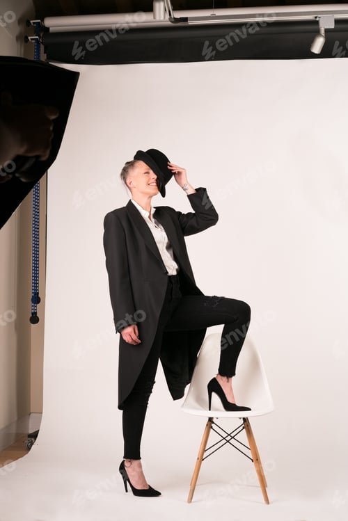 Preview: Portrait of a young woman with dark tailcoat shot in studio