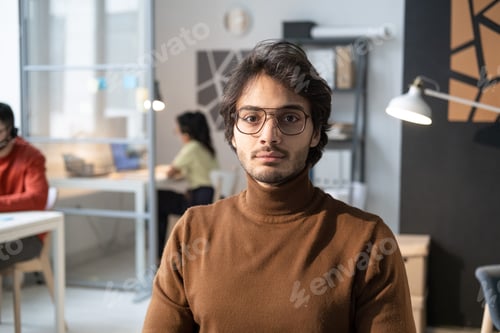 Preview: Young businessman sitting at office
