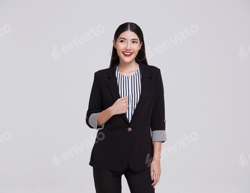 Preview: portrait of an attractive asian businesswoman in suit standing with looking up