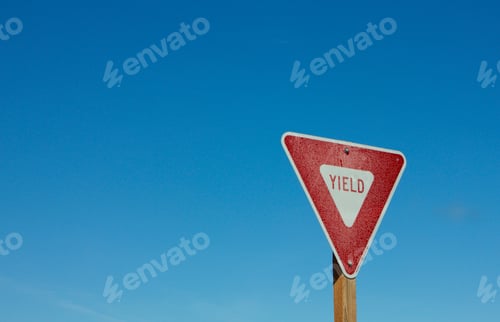 Preview: Yield sign against blue sky background room for copy
