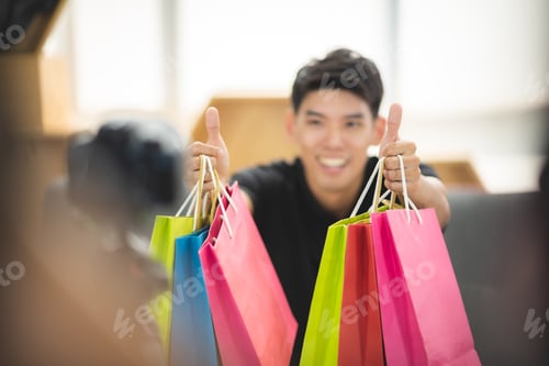 Preview: online sale social media marketing, young Asian man working with camera to live streaming to sale