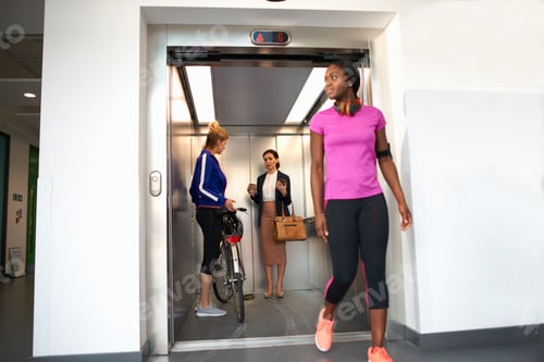 Preview: Female colleagues taking office lift