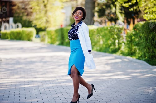 Preview: Smiling Woman Doctor Posing Outdoors in Sunlight