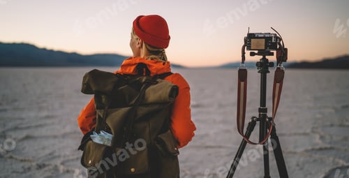 Preview: Unrecognizable female traveler contemplating near photo camera