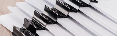 Preview: panoramic shot of arranged stacks of blank paper with metal binder clips