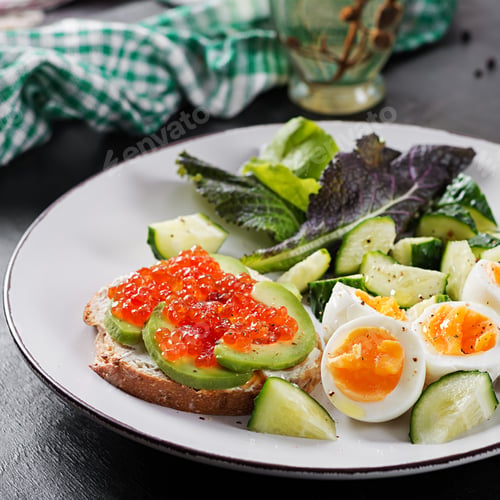 Preview: Breakfast. Healthy open sandwich on toast with avocado and red caviar, boiled eggs