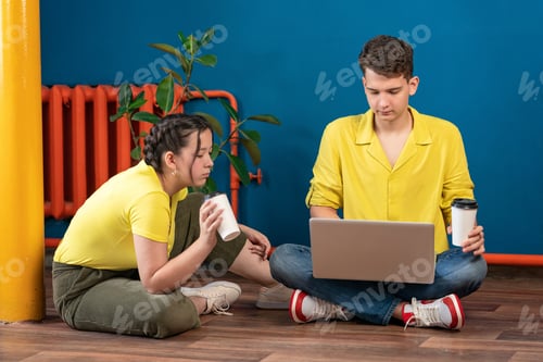 Preview: people’s drinks a tea or coffee and using laptop