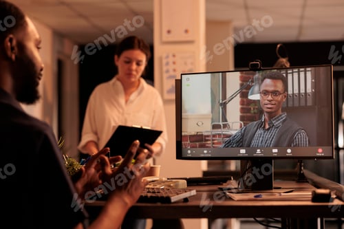 Preview: African american man talking with executive manager on videoconference