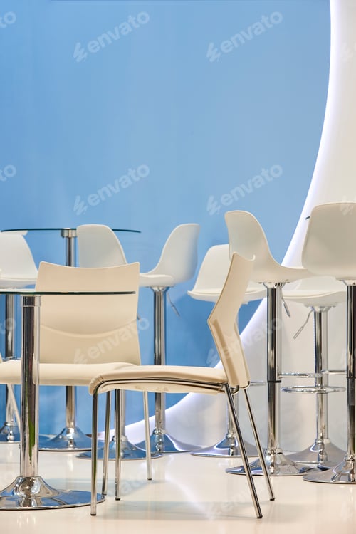 Preview: White chairs and tables in a blue room. Modern furniture