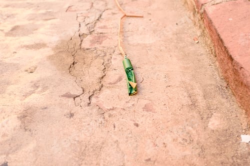 Preview: Huge firecracker on the ground before it explodes, during a celebration.