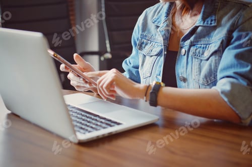 Preview: woman using smartphone and laptop
