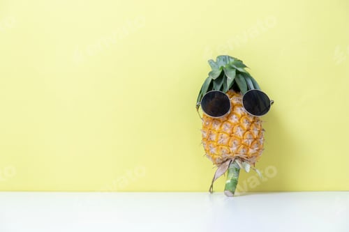 Preview: Cool Pineapple Wearing Sunglasses Against Yellow Background