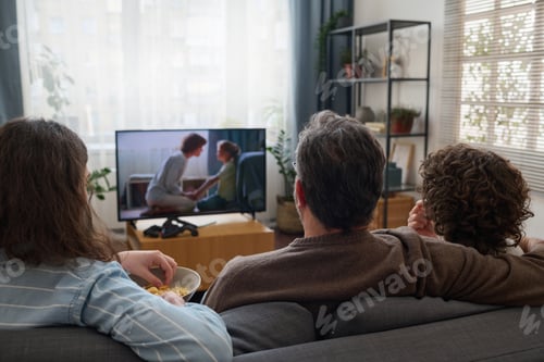 Preview: Family watching TV together in the living room