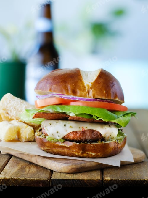 Preview: vegan cheese burger on pretzal bun and meatless bacon