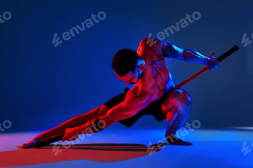 Preview: athlete men silhouette with stick training karate using sports tool in studio on colorfull lights