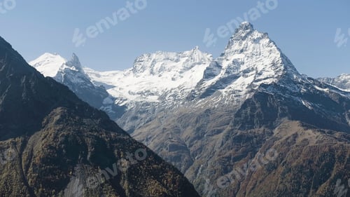 Preview: Aerial view of breathtaking mountains with snow covered sharp peaks. Creative. Mountain range on a