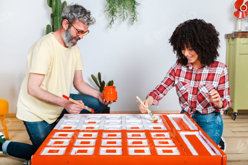 Preview: Couple painting furniture with brush at home