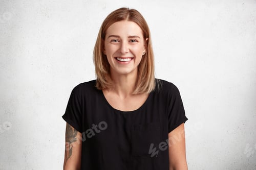 Preview: Waist up portrait of beautiful smiling young woman with positive expression, wears casual black t sh