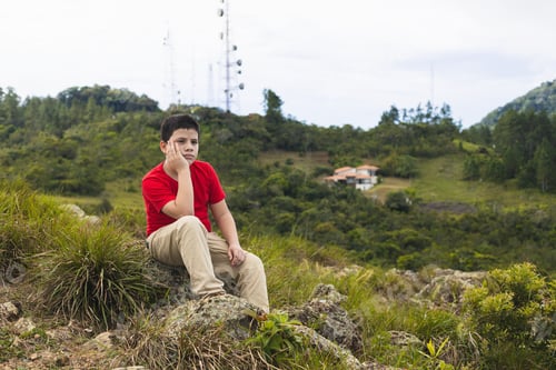 Preview: latin child sitting with hand on face