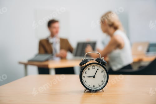 Preview: Workplace with alarm clock in modern style on background business meeting