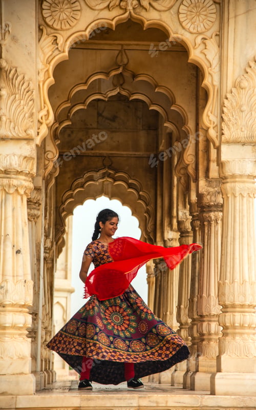 Preview: Young female tourist dancing between arches and Pillars.