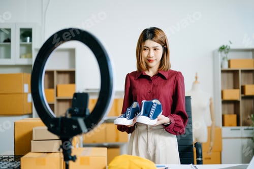 Preview: Fashion influencer presents sneakers during livestream with ring light. Perfect for ecommerce,