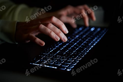 Preview: Typing on laptop keyboard at night, close up