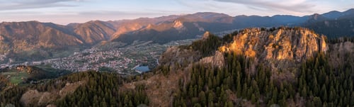 Preview: Sunrise view of a spring mountain and a small town between the slopes