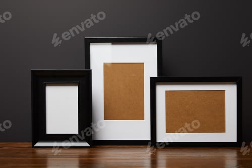 Preview: black blank square frames on wooden table
