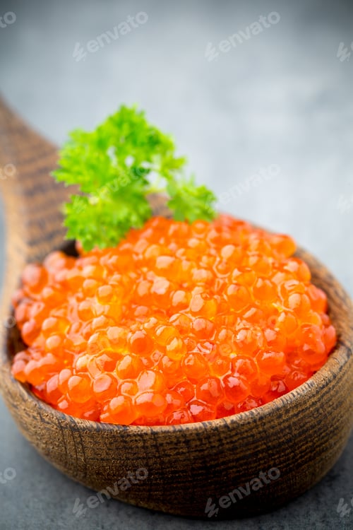 Preview: Salmon caviar with spoon on gray background.