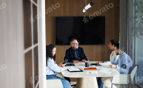 Preview: Multiracial colleagues working inside business office with glass walls