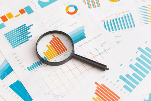 Preview: Magnifying Glass Analyzing Business Data and Graphs