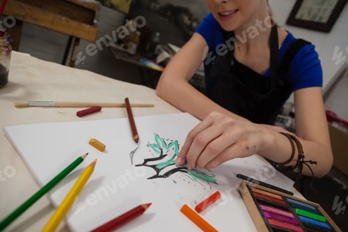 Preview: Attentive woman sketching in drawing book