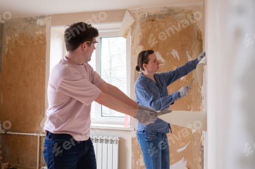 Preview: Couple Removing Wallpaper Together in Sunny Room