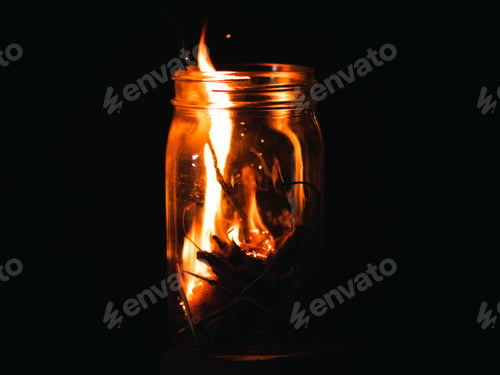 Preview: Closeup shot of burning twigs in a glass jar