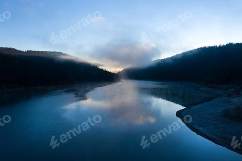 Preview: Aerial view of a misty lake during sunrise