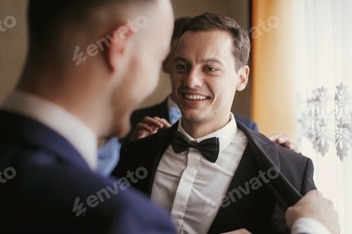 Preview: Groom getting ready in the morning with groomsmen in the room