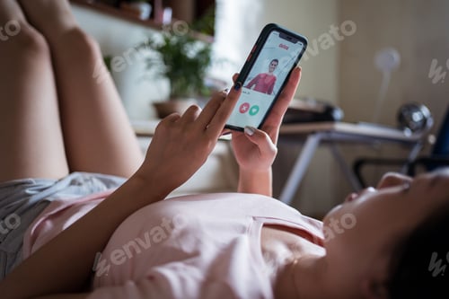 Preview: Asian female browsing dating app on bed