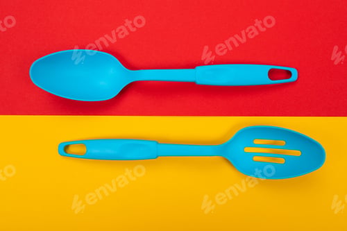 Preview: Plastic kitchen tools isolated on yellow-red background