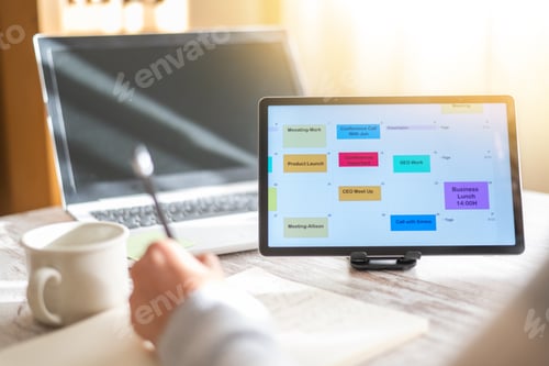 Preview: Person planning schedule using digital calendar on tablet screen