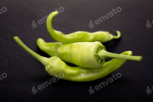 Preview: Green pepper isolated on black background.