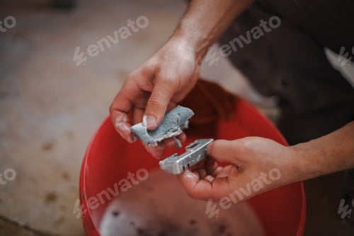 Preview: Caucasian man washes window frame details.